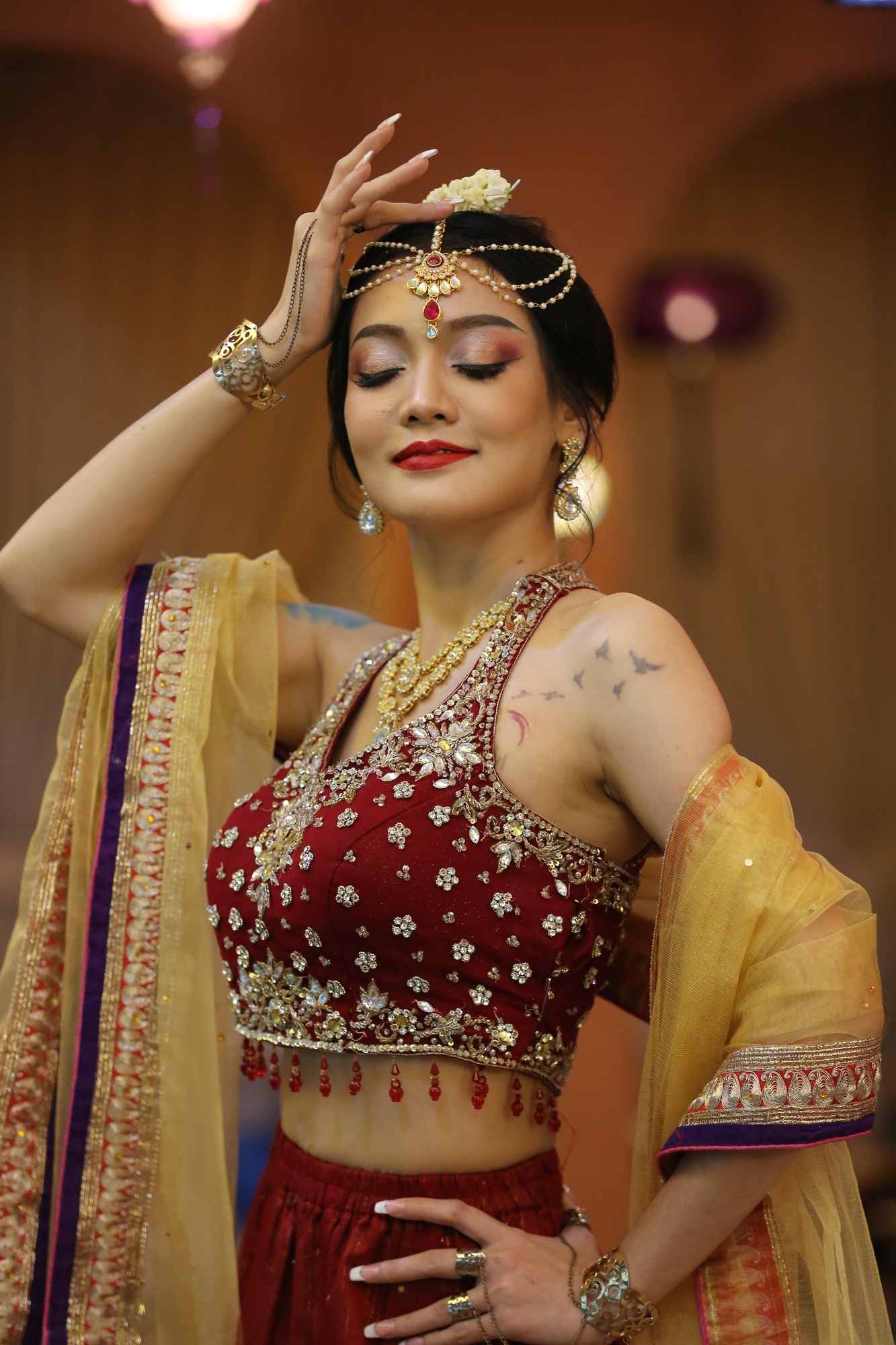 harming young woman wearing traditional saree, indoor